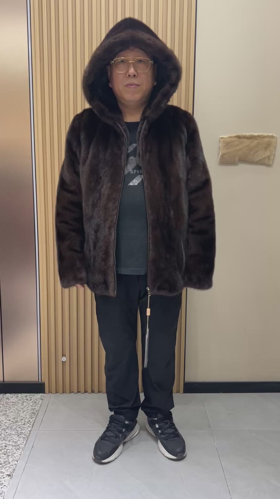 No. 126 Men's dark brown hooded mink coat with front zip closure.
