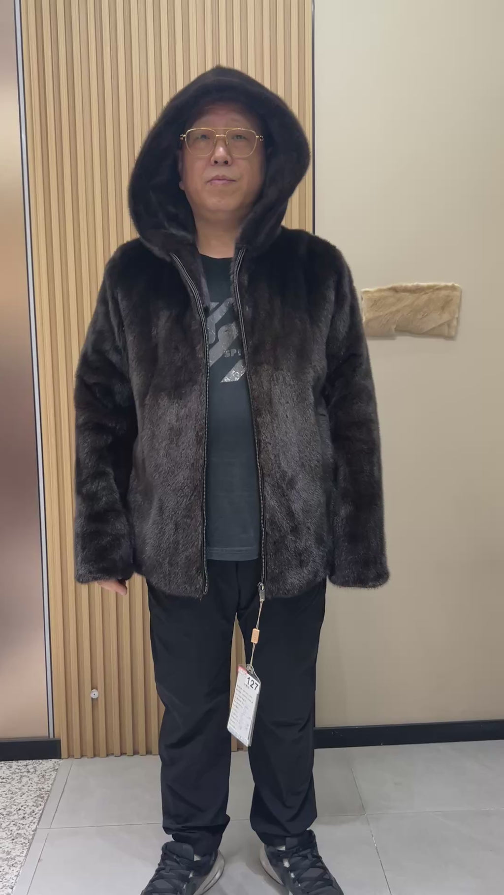No. 127 Men's dark brown hooded mink coat with front zip closure.