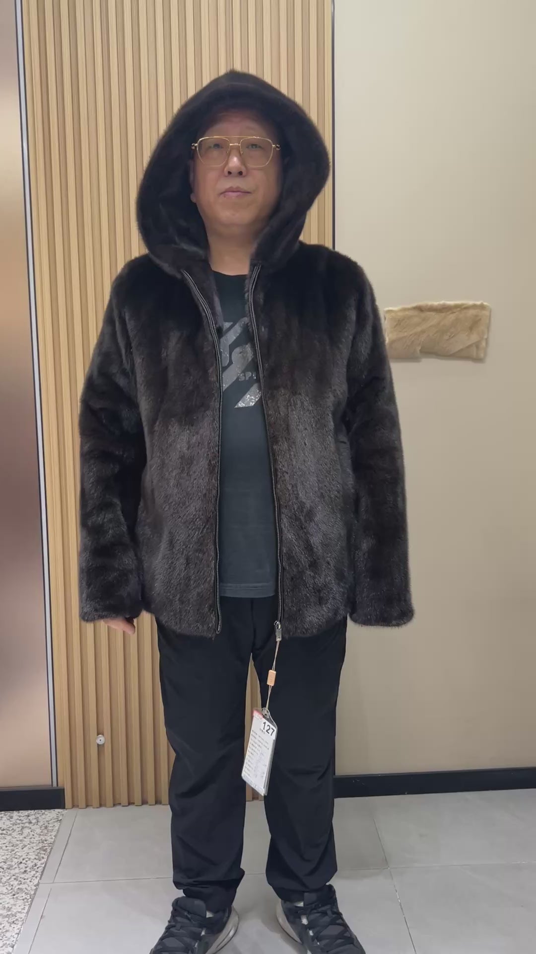 No. 127 Men's dark brown hooded mink coat with front zip closure.