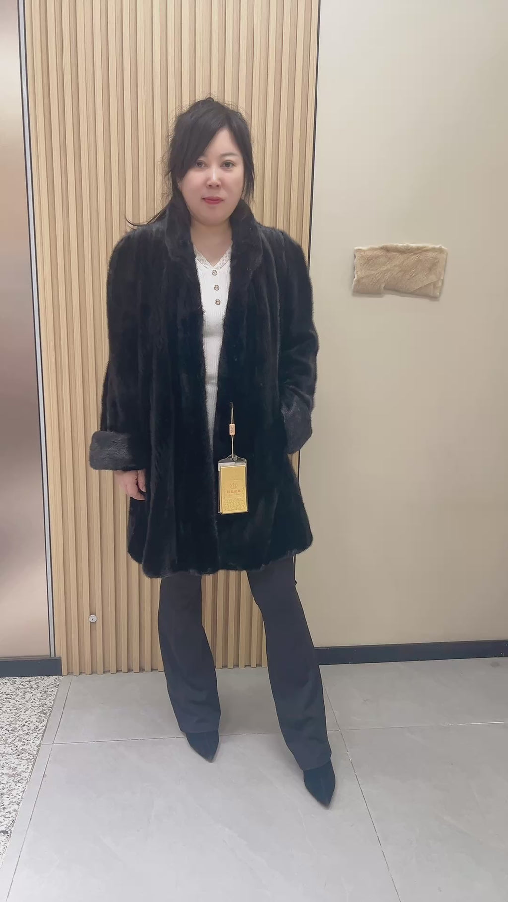 No. 209 black mink coat, mid-length, featuring a stand collar and turn-back cuffs.