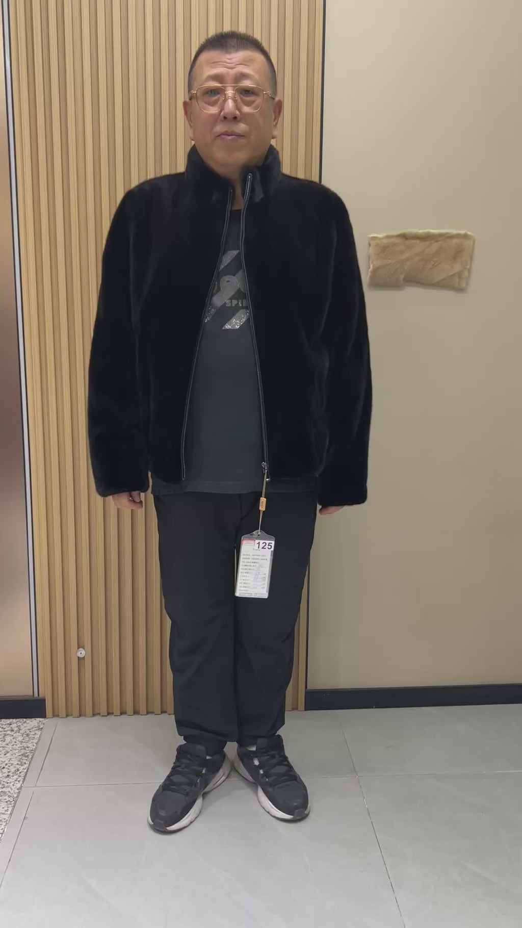 No. 125 Men's black mink coat, featuring a stand-up collar and a front zip closure.