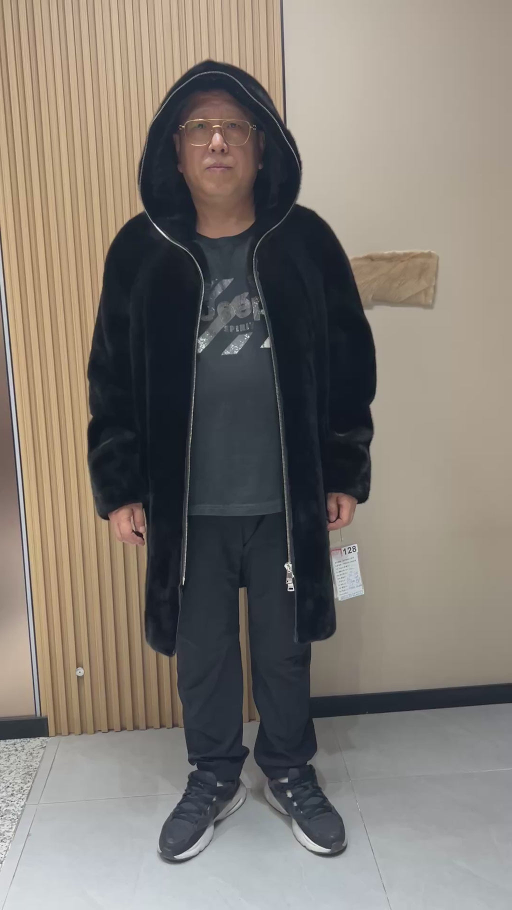 No. 128 Men's black long-length hooded mink coat with front zip closure.