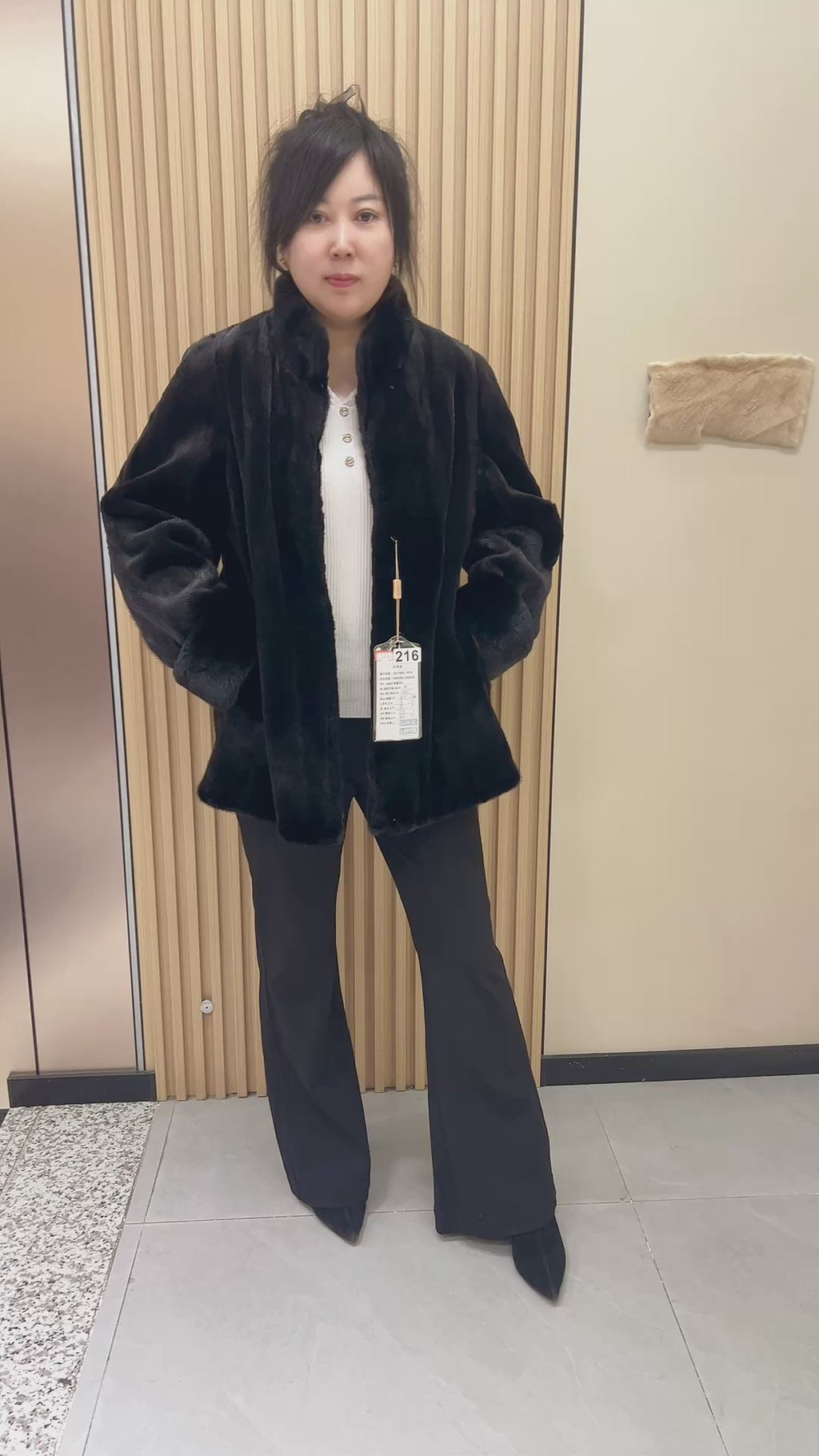 No. 216 black mink fur coat, featuring a stand collar and turn-back cuffs.
